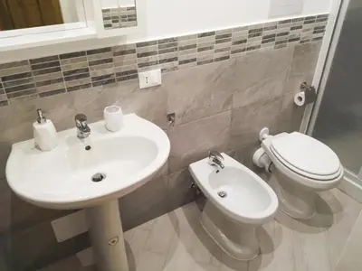 a bathroom with a sink and a toilet at Madinah apartments in Palermo