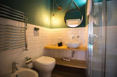 a bathroom with a sink and a toilet and a mirror at B&B Da Peppa in Castellammare del Golfo