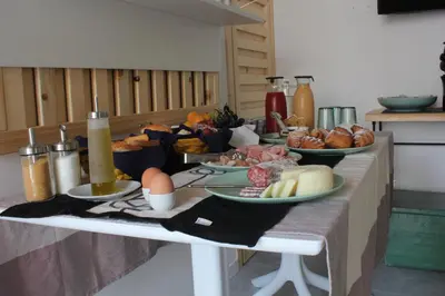 a table with several plates of food on it at B&B Da Peppa in Castellammare del Golfo