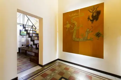 a hallway with a large painting on the wall at Il Drago e la Fenice in Palermo
