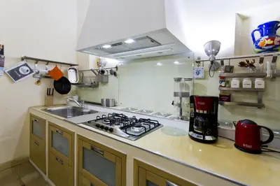 a kitchen with a stove and a sink at Il Drago e la Fenice in Palermo