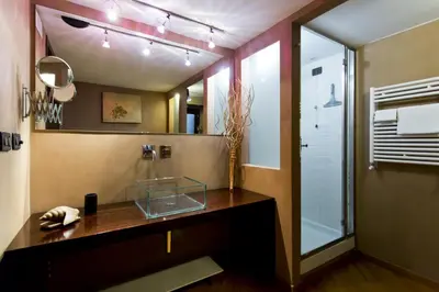 a bathroom with a counter and a mirror at Il Drago e la Fenice in Palermo