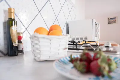a counter with a plate of fruit and a basket of eggs at Centro Casa Monteleone in Palermo