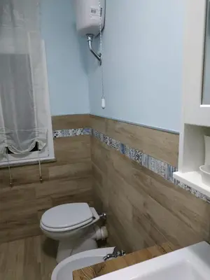 a bathroom with a toilet and a sink at Alla Casetta in Palermo