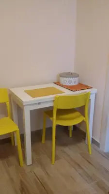a table with two yellow chairs and a table and a table and chairs at Alla Casetta in Palermo