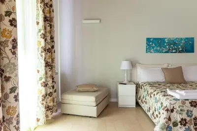 a bedroom with a bed with a ottoman next to a window at Il Sonno dei Giusti Apartment by DomuSicily in Palermo