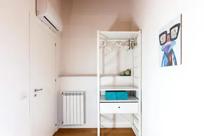a dressing room with a white closet with a mirror at Il Sonno dei Giusti Apartment by DomuSicily in Palermo