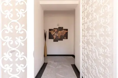 a hallway with a door with a wall with a mural at Il Sonno dei Giusti Apartment by DomuSicily in Palermo