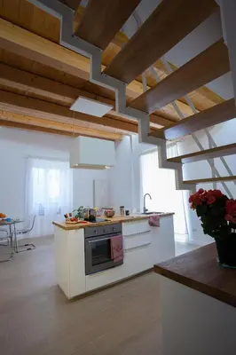 a kitchen with white appliances and wooden ceilings at Il Sonno dei Giusti Apartment by DomuSicily in Palermo