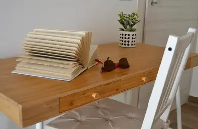 a wooden table with a stack of books on it at B&B Vivere San Vito Lo Capo in San Vito lo Capo