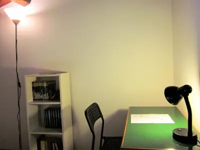 an office with a desk with a lamp and a book shelf at icalderai in Palermo