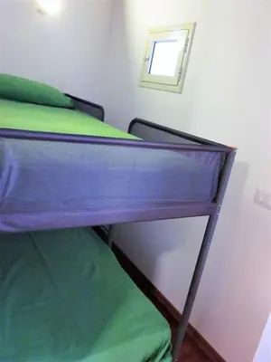a bed in a room with a mirror on the wall at icalderai in Palermo