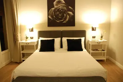a bedroom with a large bed with two night stands at Maxim in Palermo