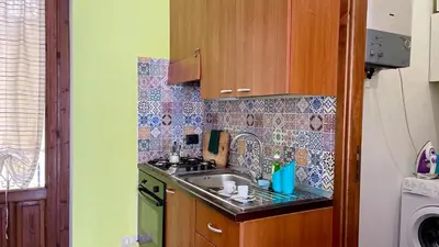 a kitchen with a sink and a stove at Khalisa Home in Palermo