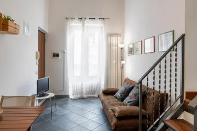 a living room with a couch and a television at Khalisa Home in Palermo