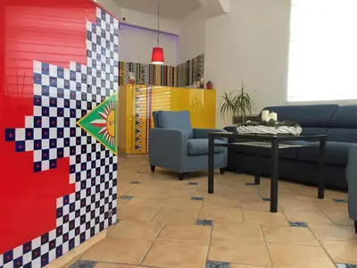 a living room with a table and chairs at Petruso Resort e SPA in Balestrate