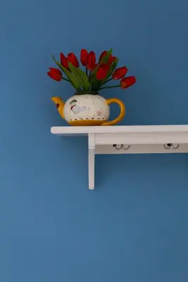 a vase with flowers in it sitting on a shelf at dallo Zio Totò in Palermo
