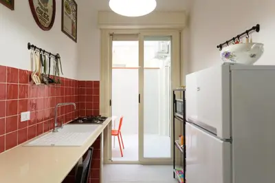 a kitchen with a sink and a refrigerator at dallo Zio Totò in Palermo