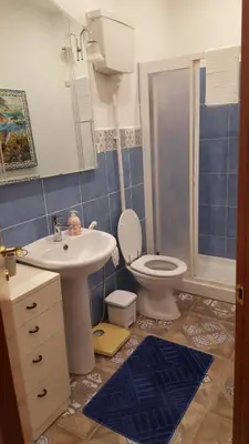 a bathroom with a white sink and a toilet at Casa Baarìa in Bagheria