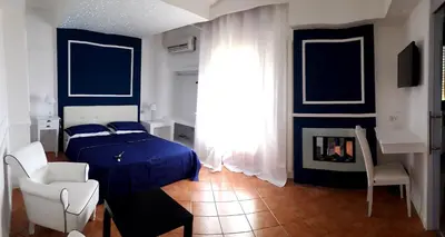a bedroom with a blue bed and a fireplace at Rocca Di Monreale in Monreale