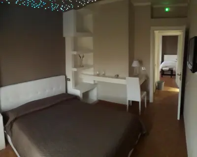 a bedroom with a bed and a room with a bed and a desk at Rocca Di Monreale in Monreale