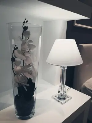 a vase filled with rocks on a table next to a lamp at Rocca Di Monreale in Monreale
