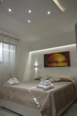 a bedroom with a bed with two towels on it at Casa Catalano in San Vito lo Capo