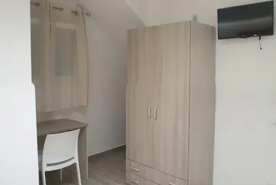 a room with a cabinet and a table and a desk at Casa Catalano in San Vito lo Capo
