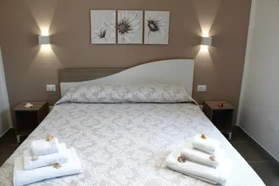 a bedroom with a bed with towels on it at Casa Catalano in San Vito lo Capo