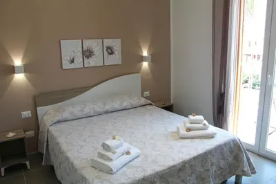 a bedroom with a bed with two towels on it at Casa Catalano in San Vito lo Capo