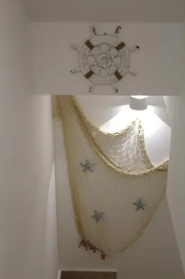 a boat hanging from the ceiling of a room at Casa Catalano in San Vito lo Capo