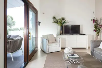 a living room with a couch and a tv at Nettuno in Cefalù