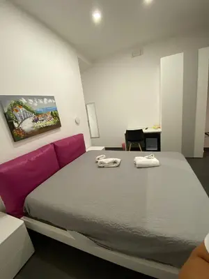 a bedroom with a large bed with two towels on it at Amuri Room&Suite in Palermo