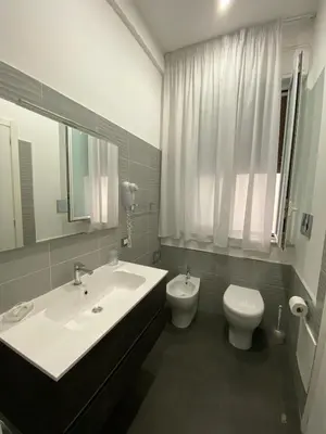 a bathroom with a sink and a toilet at Amuri Room&Suite in Palermo