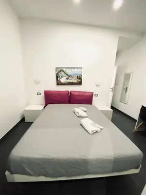 a bedroom with a large bed with two towels on it at Amuri Room&Suite in Palermo