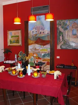 a red table with food and candles on it at B&B Casa Degli Artisti in Palermo