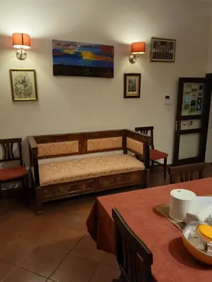 a bedroom with a bed and two tables and chairs at B&B Casa Degli Artisti in Palermo