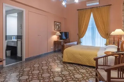 a hotel room with a bed and a mirror at palazzo pantaleo in Palermo