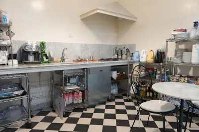 a kitchen with a sink and a checkered floor at palazzo pantaleo in Palermo