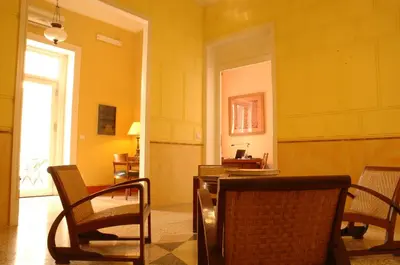 a room with chairs and a table and a window at palazzo pantaleo in Palermo