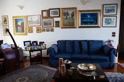 a living room with a blue couch and a table at Incantevole E A Due Passi Dal Centro in Palermo