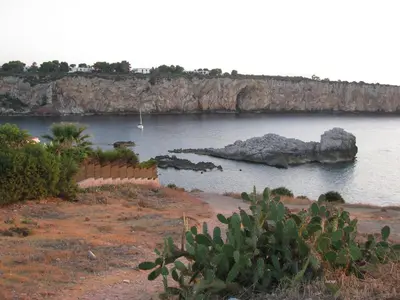 a body of water with a rock in the water at Kunesias B&B in Cinisi