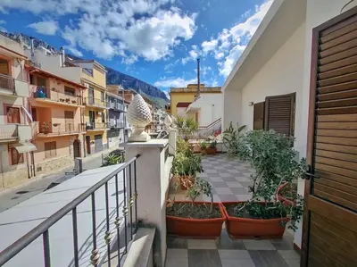 a balcony with plants in pots on a building at Kunesias B&B in Cinisi