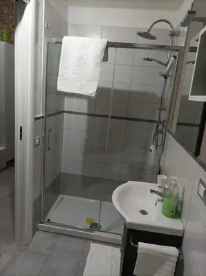 a bathroom with a shower and a sink at La Casetta Di Marta ai Quattro Canti in Palermo
