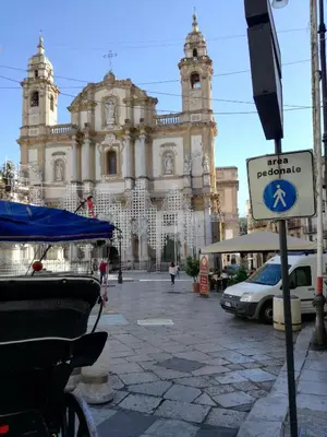 a large building with a street sign in front of it at La Casetta Di Marta ai Quattro Canti in Palermo