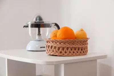 a basket of oranges on a table with a blender at Porta Nuove Vacanze in Palermo