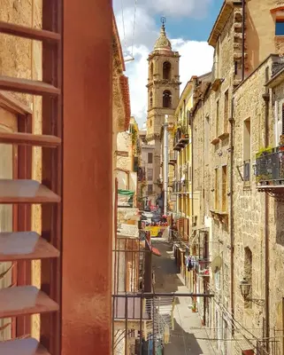a view from a window of a street with a church at Il Grazioso Giardinaccio in Palermo