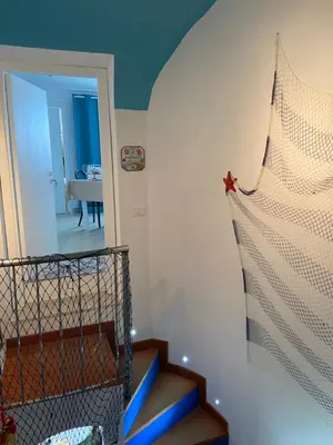 a room with a staircase and a room with a mirror at Casa vacanze Al porticciolo romantico in Trappeto