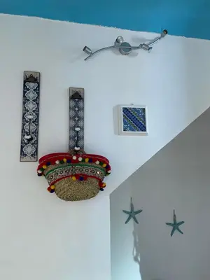 a white wall with some decorations on it at Casa vacanze Al porticciolo romantico in Trappeto