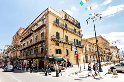 a group of people crossing a street in a city at Vista Cattedrale in Palermo